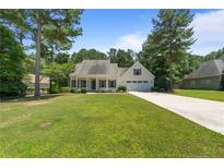 Charming single-Gathering home featuring a well-manicured lawn and attached two-car garage at 120 Timberwood Dr, Carthage, NC 28326