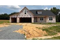 New home under construction featuring a two-car garage, neutral siding, and dark roof in a lovely neighborhood at 171 Surles Landing Way, Benson, NC 27504
