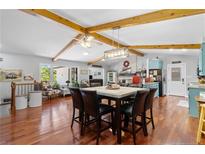 Open dining room featuring hardwood floors, wood beam ceiling, and a rustic-style light fixture at 185 Tree Cutters, Sanford, NC 27332