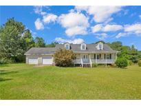 Charming home featuring a welcoming front porch and a spacious two-car garage at 1862 Nc 87 S, Cameron, NC 28326
