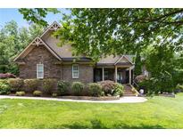 Charming brick home with well-manicured lawn and mature landscaping at 3027 Carrington Ln, Sanford, NC 27330