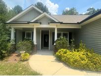 Charming single story home with a covered porch and well-manicured landscaping at 138 Gold Ct, Broadway, NC 27505