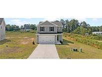 Charming two-story home with a gray exterior, a two-car garage, and a well-manicured lawn at 29 Red Bird Dr, Cameron, NC 28326