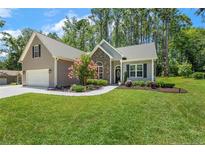 Charming home with landscaped front yard, stone accents, gray siding, and attached garage at 787 Cashmere Ct, Sanford, NC 27332
