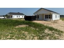 New single story construction with white siding and black roof on a grass lot at 5964 Godwin Lake Rd, Benson, NC 27504