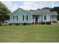 Charming single-story home with light blue siding, dark shutters and a well-manicured front lawn at 108 Shady Meadows Ln, Clayton, NC 27520