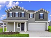 Two-story home featuring a neutral palette, black shutters, gray siding, and a covered front entryway at 534 Stadium Drive, Cameron, NC 28326