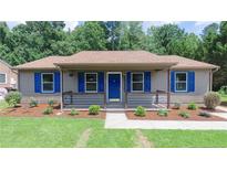 Charming single-story home featuring a covered front porch and blue shutters at 106 Deep Forest Dr, Durham, NC 27713