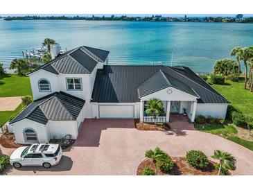 Luxury waterfront home with a metal roof and expansive water views at 443 Picasso Dr, Nokomis, FL 34275