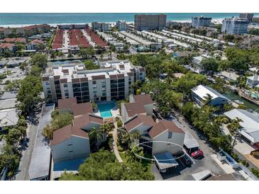 Beautiful aerial view of a condo community with a pool, carport, and lush greenery near the beach at 6157 Midnight Pass Rd # C11, Sarasota, FL 34242