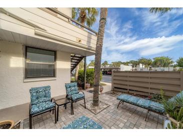 Private patio offers comfortable seating with a charming view of lush landscaping and a clear blue sky at 445 Palm Tree Dr, Bradenton, FL 34210
