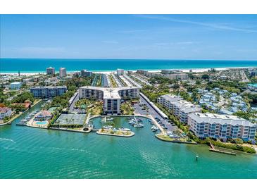 Aerial view of waterfront property with tennis courts and a marina at 5855 Midnight Pass Rd # 416, Sarasota, FL 34242