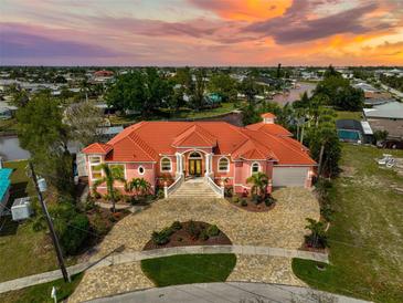 Luxury waterfront home with a stunning sunset view and private dock at 4409 Crews Ct, Port Charlotte, FL 33952