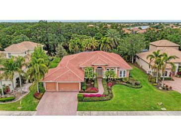 Aerial view of a single-Gathering home with a red tile roof and lush landscaping at 3763 Eagle Hammock Dr, Sarasota, FL 34240