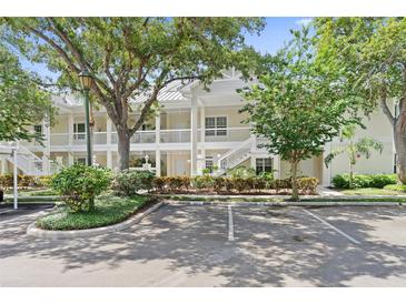 Two-story condo building with white exterior, balconies, and landscaping at 3702 54Th W Dr # 102, Bradenton, FL 34210