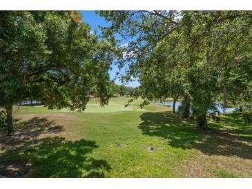 Scenic golf course view framed by lush trees at 6736 Fairview Ter # 6736, Bradenton, FL 34203