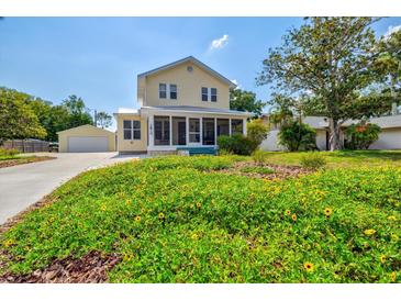 Charming yellow house with a screened porch and a lush front yard at 1810 28Th W St, Bradenton, FL 34205