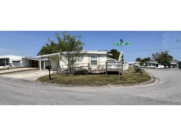 Single-wide manufactured home with ramp access, carport and fenced yard at 4906 Sea Island Ave, Sarasota, FL 34234