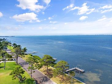 Aerial view showing waterfront property with private dock and lush landscaping at 358 Suwanee Ave, Sarasota, FL 34243