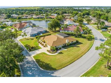 Aerial view of a single Gathering home on a cul-de-sac with a lake in the background at 6986 Country Lakes Cir, Sarasota, FL 34243