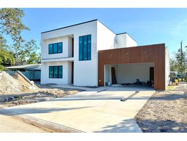 Contemporary two-story home with clean lines and a spacious driveway, in the process of being completed at 2226 Grove St, Sarasota, FL 34239