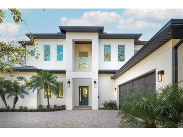Modern two-story home with white facade, dark gray roof, and a welcoming front entrance at 2420 Floyd St, Sarasota, FL 34239