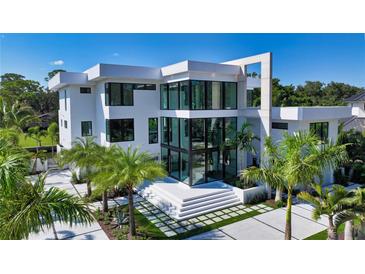 Modern white two-story home with a sleek design and palm trees at 1610 N Lodge Dr, Sarasota, FL 34239