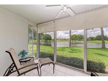 Relaxing sunroom with lake view and comfortable seating at 5519 Fair Oaks St # 2-D, Bradenton, FL 34203