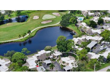 Aerial view showcasing home's location in a community near a golf course and lake at 2517 Glebe Farm Close # H-2, Sarasota, FL 34235