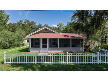 Cute bungalow with a white picket fence and a screened porch at 708 61St E St, Palmetto, FL 34221