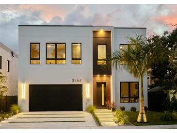 Modern two-story home with a sleek design and attached garage at 3464 Camino Real, Sarasota, FL 34239