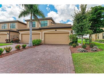 Charming two-story home featuring a spacious three-car garage, beautifully landscaped yard, and brick-paved driveway at 6708 Grand Estuary Trl # 104, Bradenton, FL 34212