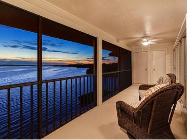 Spacious balcony with sunset views and wicker furniture at 3825 Mariners Walk # 622, Cortez, FL 34215