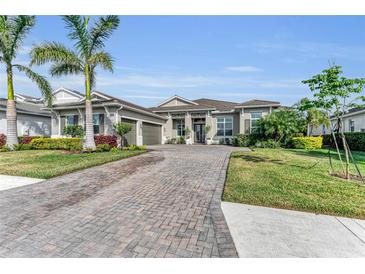 Beautiful home with a paver driveway and lush landscaping at 17745 Lucaya Dr, Lakewood Ranch, FL 34202