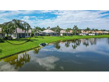 Aerial view of home showcasing a lakefront location and lush landscaping at 4043 Caddie E Dr, Bradenton, FL 34203