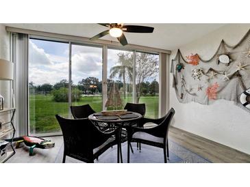 Sunroom with wicker furniture and view of the golf course at 4480 Fairways Blvd # 109, Bradenton, FL 34209