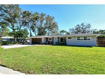 Updated ranch home with modern facade, landscaping, and two-car garage at 4616 Leeta Ln, Sarasota, FL 34234