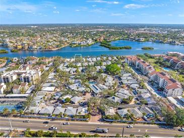 Aerial view of waterfront property with lush landscaping and nearby community at 1358 Moonmist Dr # B4, Sarasota, FL 34242