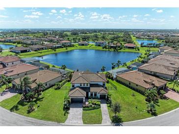 Luxury home with lakefront lot, paver driveway and lush landscaping at 14118 Florida Rosemary Dr, Bradenton, FL 34211