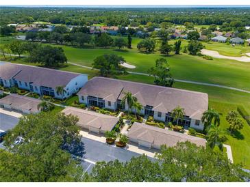 An aerial view shows the building's roof and a picturesque golf course at 6904 Drewrys Blf # 810, Bradenton, FL 34203