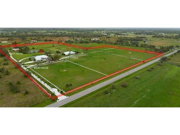 Aerial view of expansive property with main house, guesthouse, and horse stable at 3630 Verna Rd, Myakka City, FL 34251