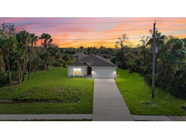 New construction home with a two-car garage and a driveway at 1800 S San Mateo Dr, North Port, FL 34288