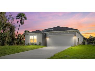 Two-story house with a light gray exterior and a landscaped yard at 1800 S San Mateo Dr, North Port, FL 34288