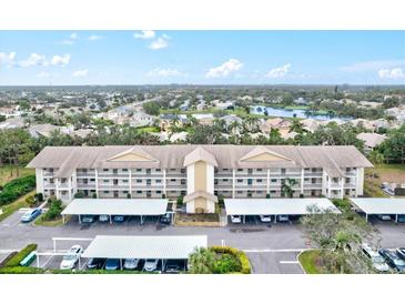 Aerial view of condo building with parking and surrounding landscape at 7201 29Th Avenue W Dr # 306, Bradenton, FL 34209