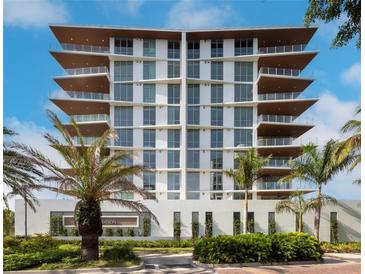 Modern multi-story building with sleek design and palm trees at 111 Golden Gate Pt # 602, Sarasota, FL 34236