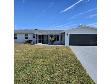 Updated single story home with a 2-car garage and well manicured lawn at 150 Rotonda Cir, Rotonda West, FL 33947