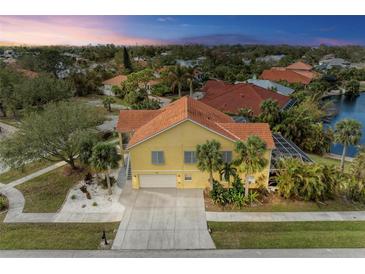 Aerial view of two story house with tile roof, two car garage, and landscaped yard at 2501 Broad St, Nokomis, FL 34275