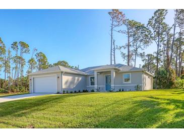 Single-story home with attached garage and landscaped lawn at 2814 Daphne Rd, North Port, FL 34288