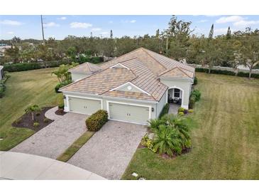 Two-story house with tile roof and two-car garage, nicely landscaped at 5450 Fairfield Blvd, Bradenton, FL 34203