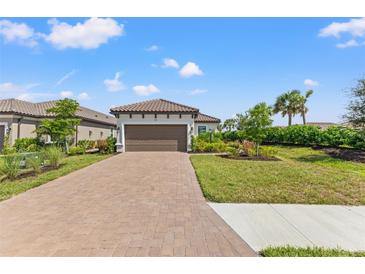 Single-story home with a paved driveway and landscaped front yard at 3121 Tolmino Ct, Bradenton, FL 34211